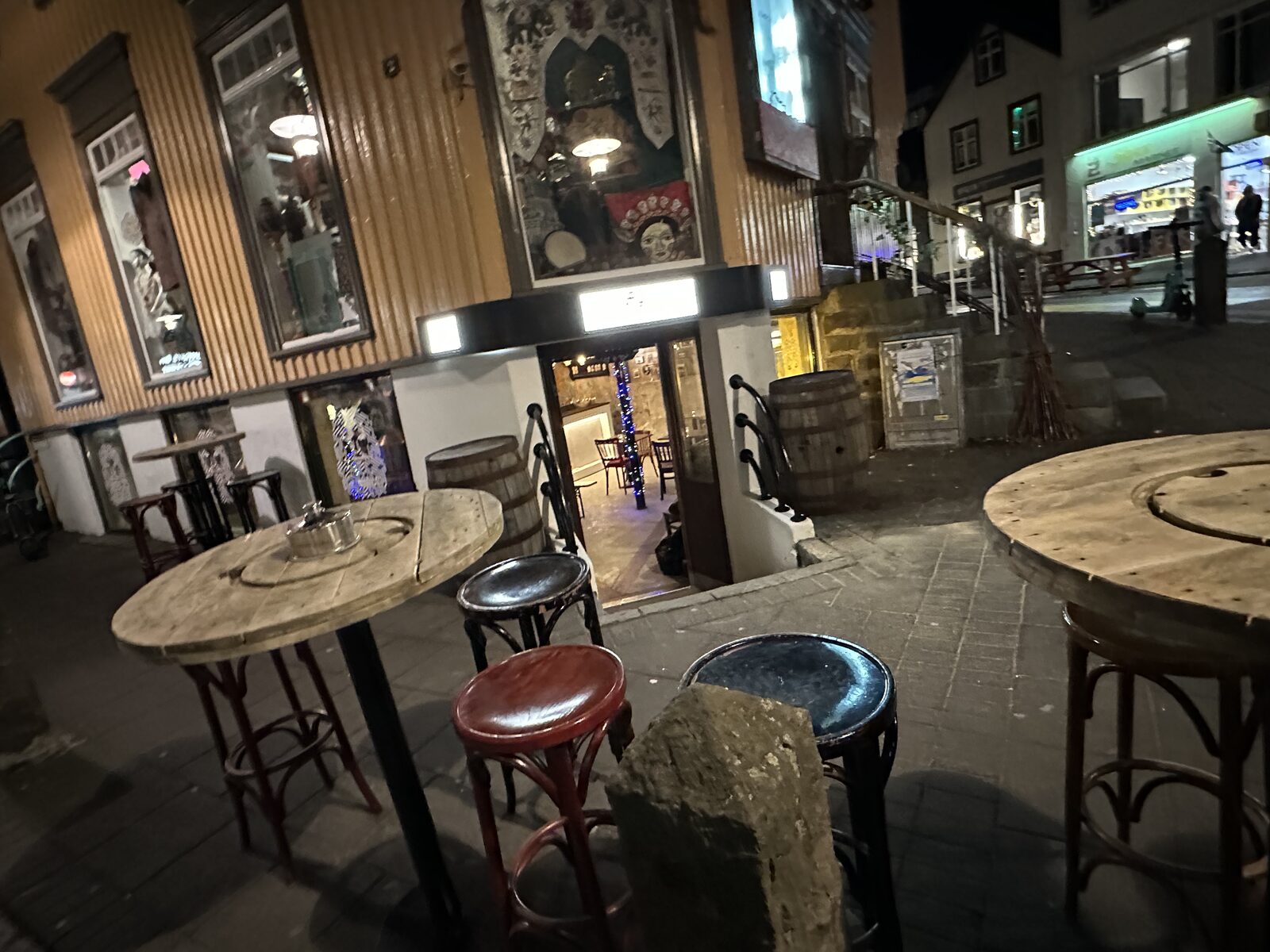 Outdoor seating outside ÆGIR 101 at night